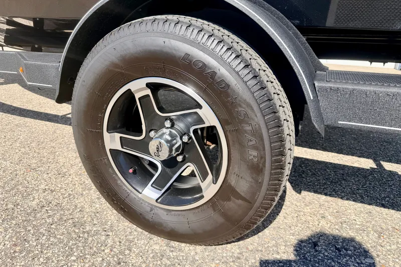 Slide: The Image of 2023 Ranger VS1665T trailer wheel with Loadstar tire on asphalt surface. - 71