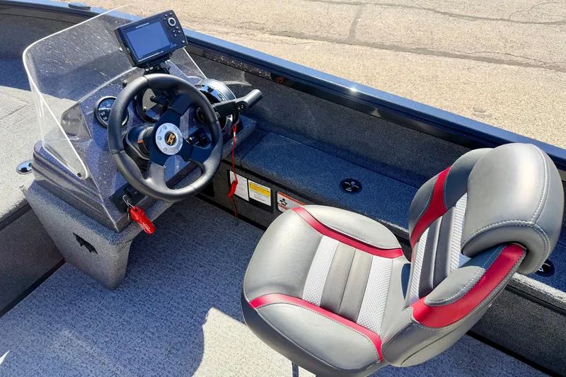 Slide: The Image of 2023 Ranger VS1665T boat interior with steering wheel and cushioned seat. - 34
