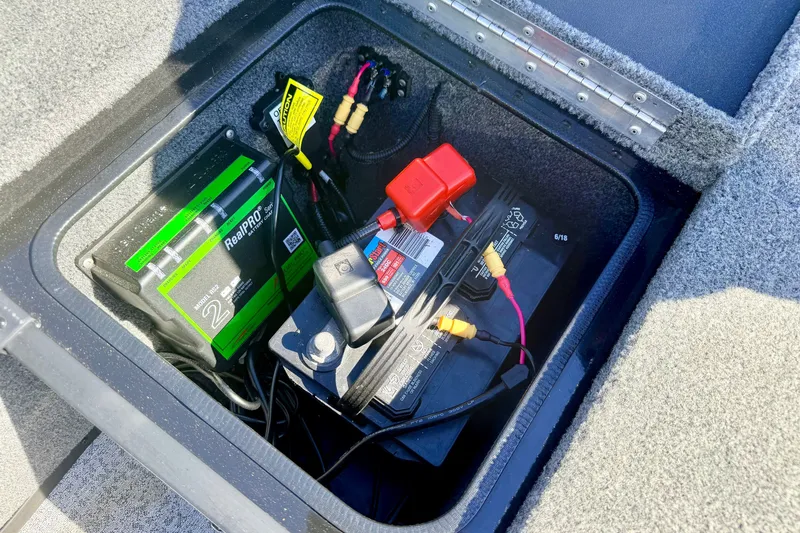 Slide: The Image of Battery compartment of 2023 Ranger VS1665T boat with RealPRO charger and wiring. - 48