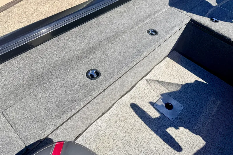 Slide: The Image of Interior of 2023 Ranger VS1665T boat, featuring carpeted flooring and storage compartments. - 30