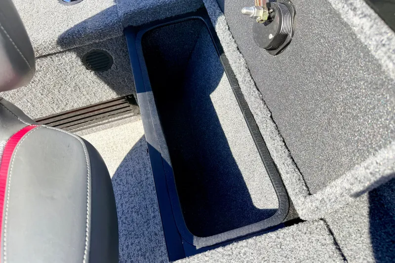 Slide: The Image of 2023 Ranger VS1665T boat interior storage compartment with open lid and seating detail. - 29