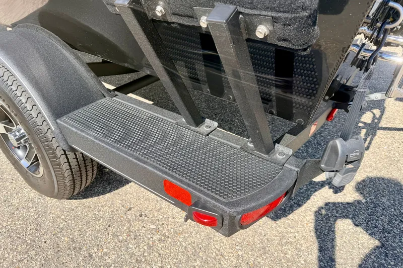 Slide: The Image of 2023 Ranger VS1665T trailer with textured step and red reflector on asphalt. - 72