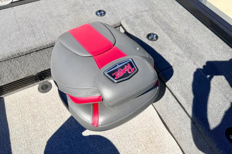 Slide: The Image of Gray and red Ranger VS1665T boat seat, 2023 model, on carpeted deck. - 33