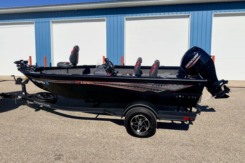 Slide: The Image of 2023 Ranger VS1665T boat with Mercury engine, parked on a trailer outside a blue building. - 4
