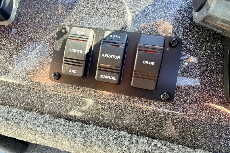 Slide: The Image of Control panel of a 2023 Ranger VS1665T boat with switches for lights, aerator, and bilge. - 41