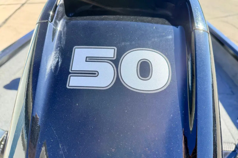 Slide: The Image of Close-up of 2023 Ranger VS1665T boat with '50' decal on dark surface. - 18