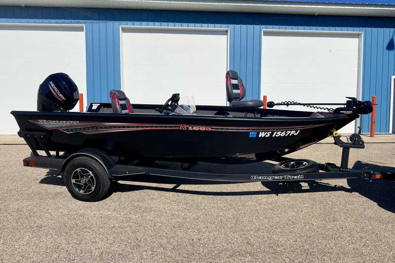Slide: The Image of 2023 Ranger VS1665T fishing boat on trailer, parked outside blue building. - 5