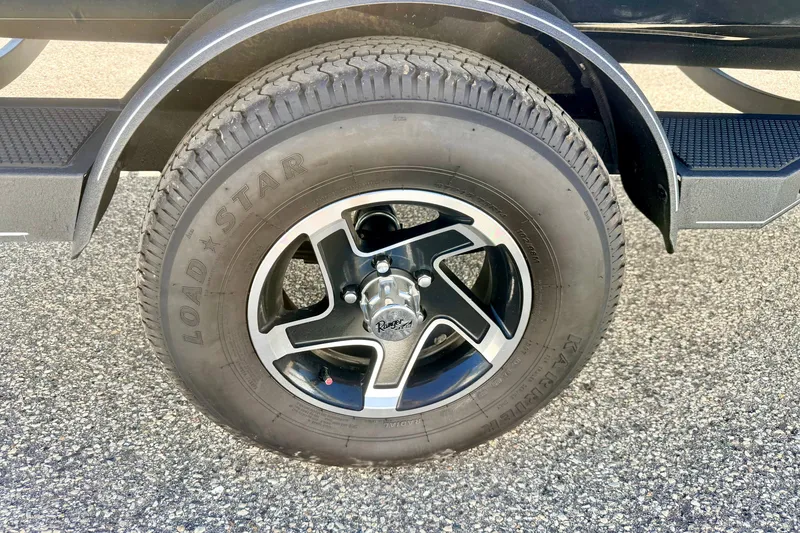 Slide: The Image of 2023 Ranger VS1665T trailer tire and wheel on asphalt surface. - 74