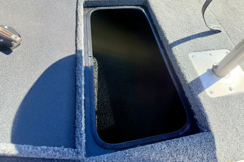 Slide: The Image of 2023 Ranger VS1665T boat storage compartment with carpeted interior. - 55