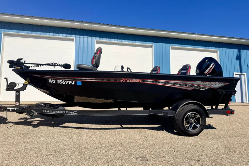 Slide: The Image of 2023 Ranger VS1665T fishing boat on trailer, parked outside blue building. - 6