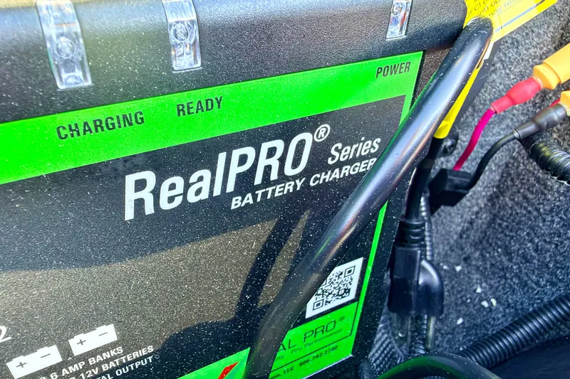 Slide: The Image of RealPRO Series battery charger in a 2023 Ranger VS1665T boat, showing charging status. - 49