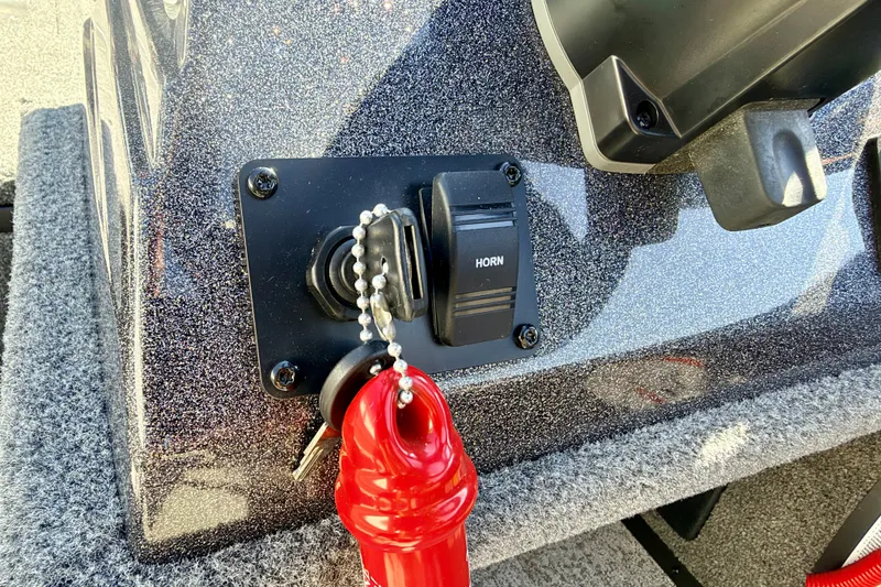 Slide: The Image of Control panel of 2023 Ranger VS1665T boat with horn switch and safety key. - 40