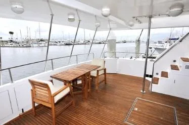 Slide: The Image of Spacious yacht deck with wooden furniture, overlooking marina, Custom model, 1989. - 29