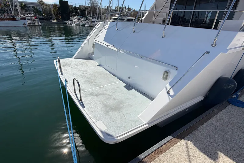 Slide: The Image of Custom 1989 yacht stern with swim platform and ladder, docked in marina. - 13