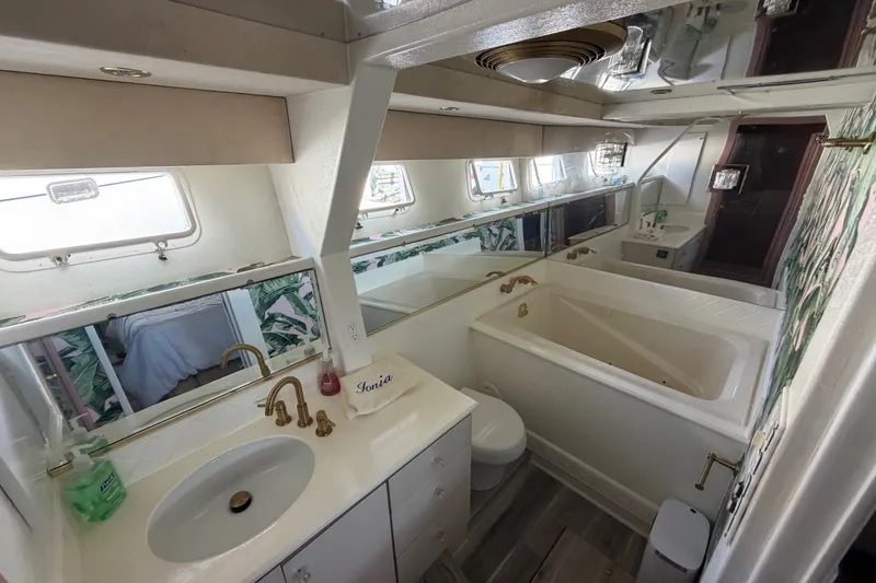 Slide: The Image of Luxurious 1989 custom bathroom with gold fixtures, large mirror, and bathtub. - 44