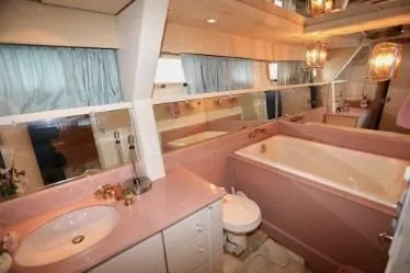 Slide: The Image of Luxurious 1989 custom bathroom with pink fixtures, large bathtub, and elegant lighting. - 35