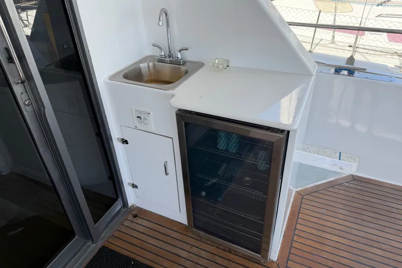 Slide: The Image of Small boat kitchenette with sink, mini-fridge, and wooden flooring, 1989 custom model. - 48