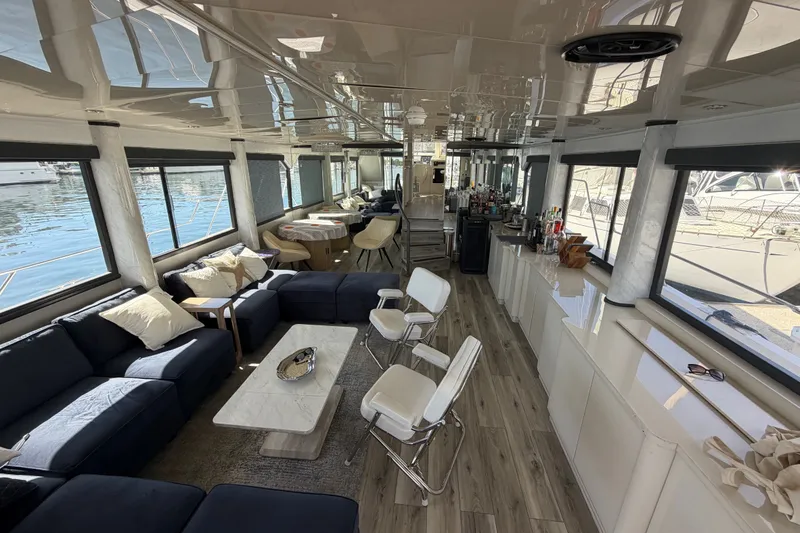 Slide: The Image of Luxurious yacht interior with modern seating, bar area, and large windows overlooking the water. - 37