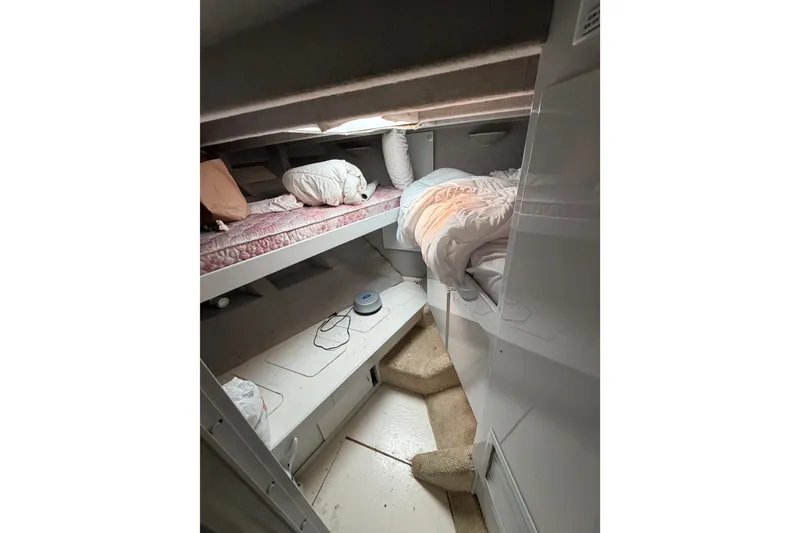 Slide: The Image of Interior of a 1989 custom boat cabin with bunk beds and cozy bedding. - 41