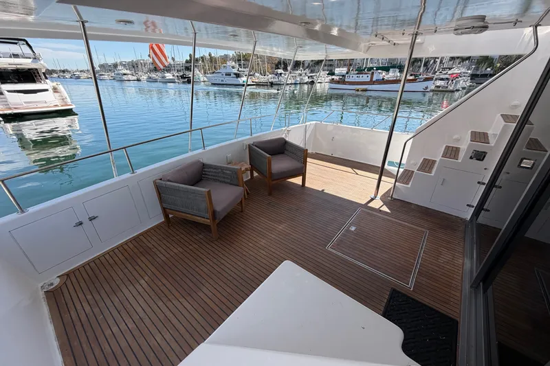 Slide: The Image of Spacious yacht deck with wooden flooring, modern seating, and marina view, 1989 custom model. - 47