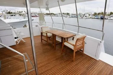 Slide: The Image of Spacious yacht deck with wooden furniture, overlooking marina. Custom model, 1989. - 28