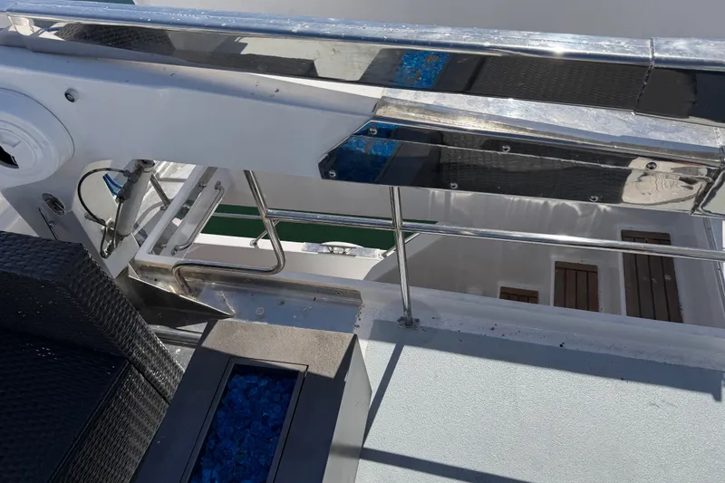 Slide: The Image of Boat deck with metal railings and seating, featuring blue decorative stones, custom 1989 model. - 45