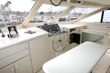 Slide: The Image of Helm of a 1989 custom boat with steering wheel and marina view. - 23