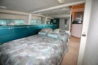 Slide: The Image of 1989 custom interior with bed, teal cabinets, and cozy decor. - 36