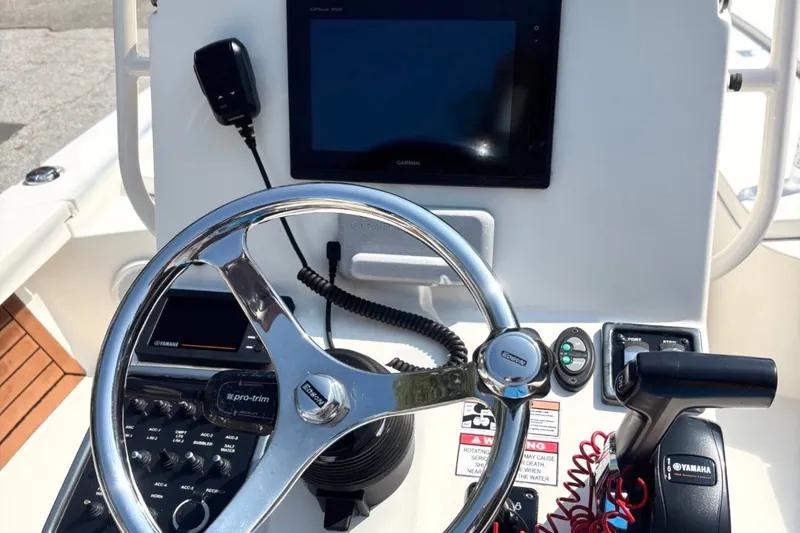 Slide: The Image of 2016 Pathfinder 2300 HPS boat dashboard with steering wheel, Garmin display, and Yamaha controls. - 14