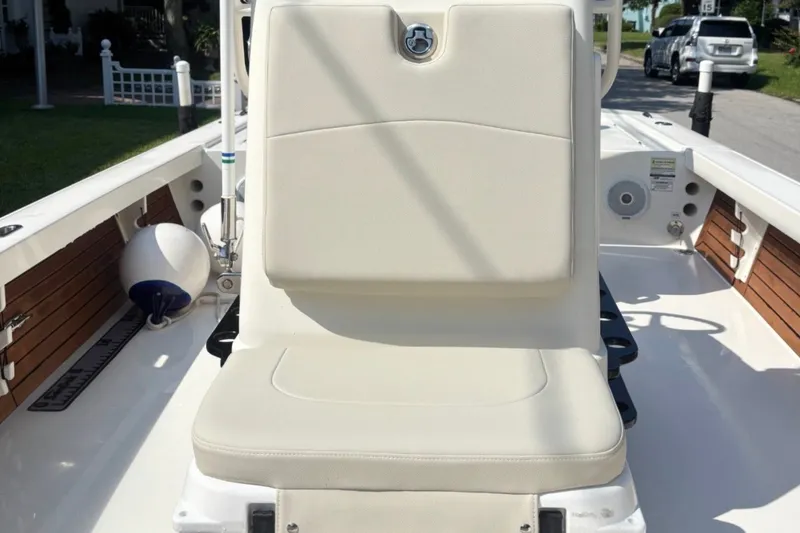 Slide: The Image of 2016 Pathfinder 2300 HPS boat interior with cushioned seating and wooden accents. - 16