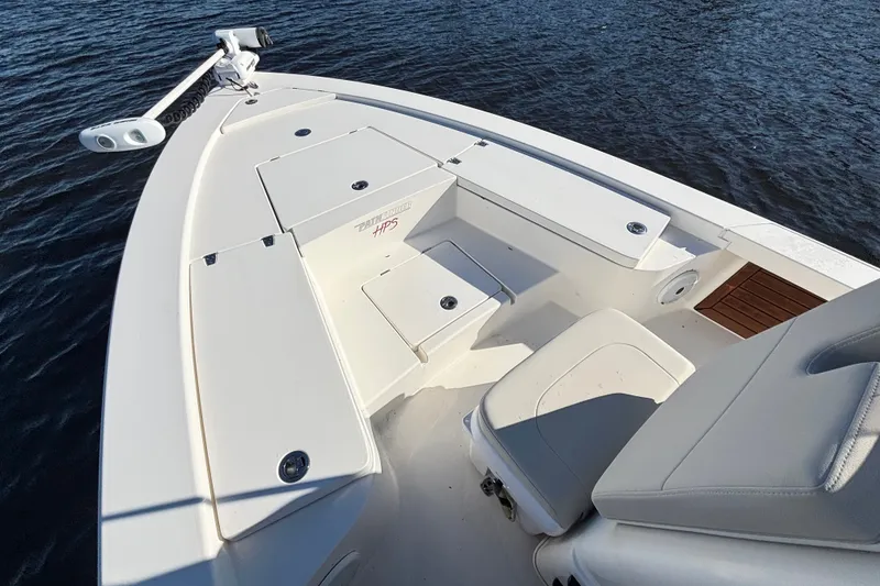 Slide: The Image of 2016 Pathfinder 2300 HPS boat deck with storage compartments on calm water. - 17