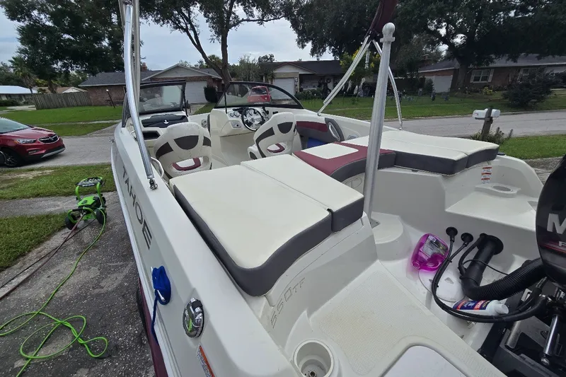 Slide: The Image of 2016 Tahoe 550 TF boat with seating, parked in a residential driveway. - 2