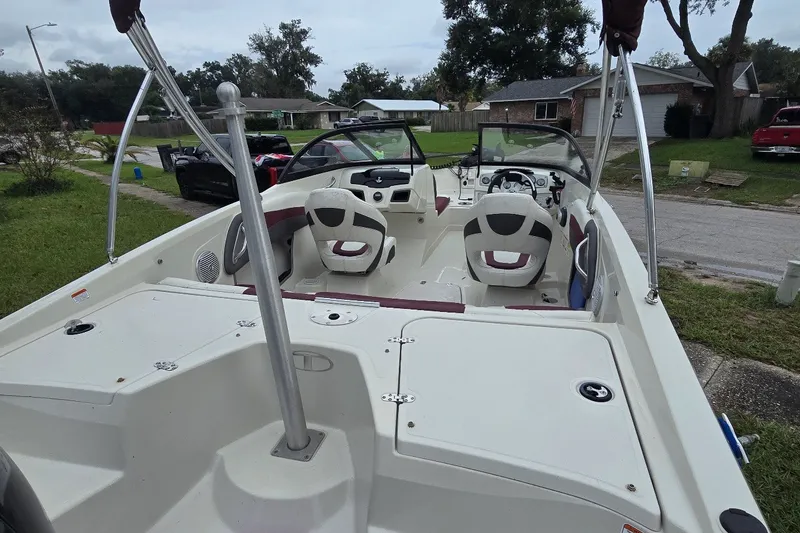 Slide: The Image of 2016 Tahoe 550 TF boat with dual seating, parked in a residential area. - 3