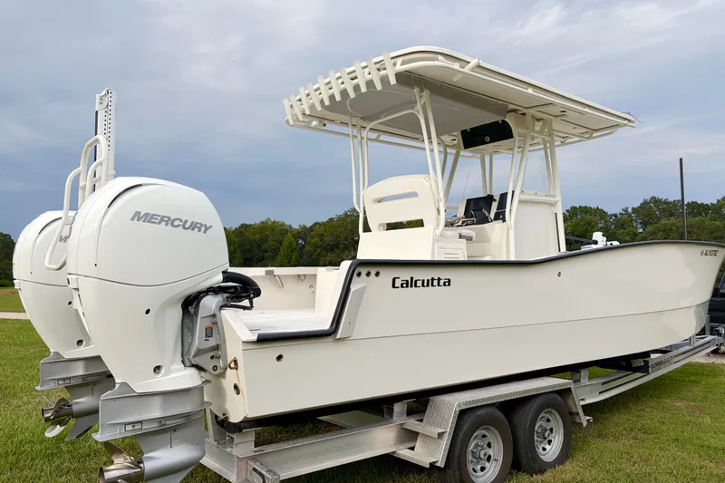 The Image of 2025 Calcutta 263 boat with dual Mercury engines on a trailer. - 0