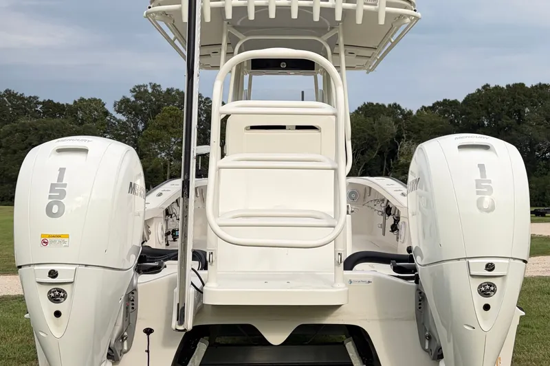 Slide: The Image of 2025 Calcutta 263 boat with dual Mercury 150 engines, parked outdoors. - 3