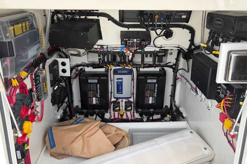 Slide: The Image of Electrical system setup in a 2025 Calcutta 263 boat, featuring batteries and wiring. - 13