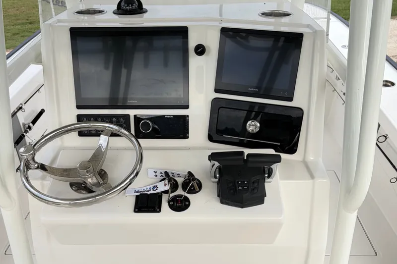 Slide: The Image of Control panel of 2025 Calcutta 263 boat with steering wheel and dual screens. - 7