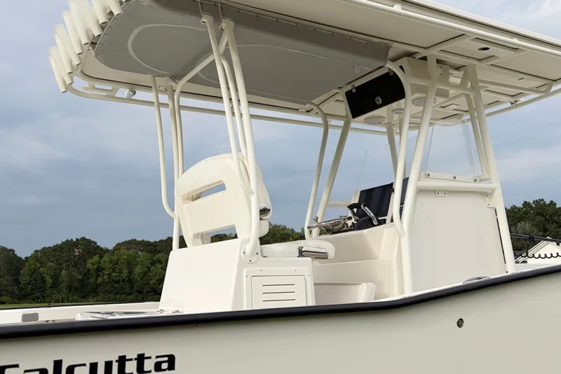 Slide: The Image of 2025 Calcutta 263 boat with T-top and console, set against a natural backdrop. - 5