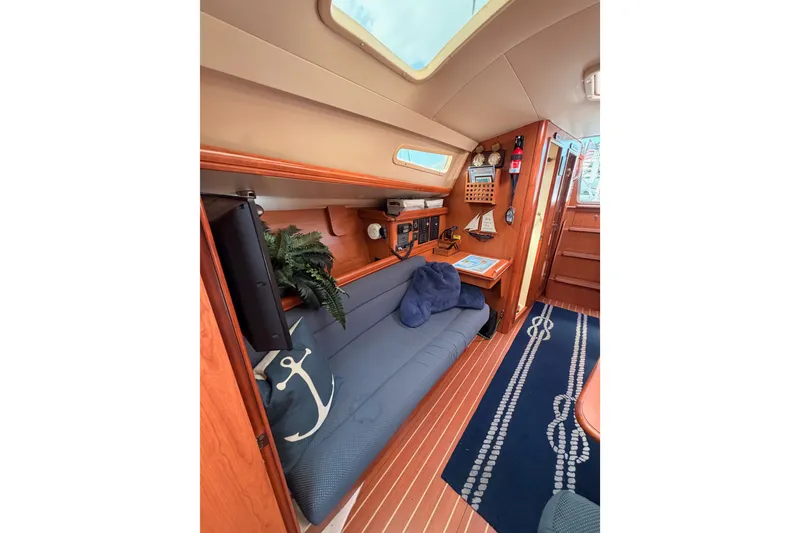 Slide: The Image of Interior of 2009 Hunter 33 sailboat with cozy seating and nautical decor. - 58