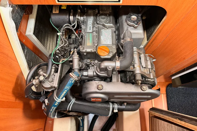 Slide: The Image of Engine compartment of a 2009 Hunter 33 sailboat, showcasing detailed mechanical components. - 62