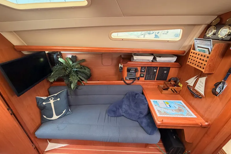 Slide: The Image of Cozy interior of 2009 Hunter 33 sailboat with seating, navigation equipment, and nautical decor. - 51