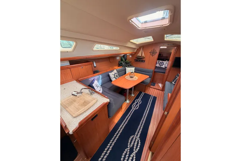 Slide: The Image of Interior of 2009 Hunter 33 sailboat with cozy seating and nautical decor. - 46