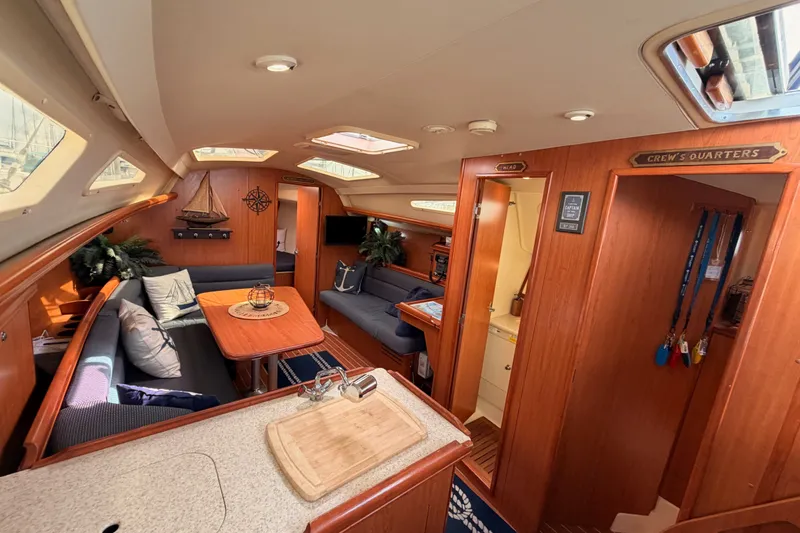 Slide: The Image of Interior of a 2009 Hunter 33 sailboat with cozy seating and wooden finishes. - 42