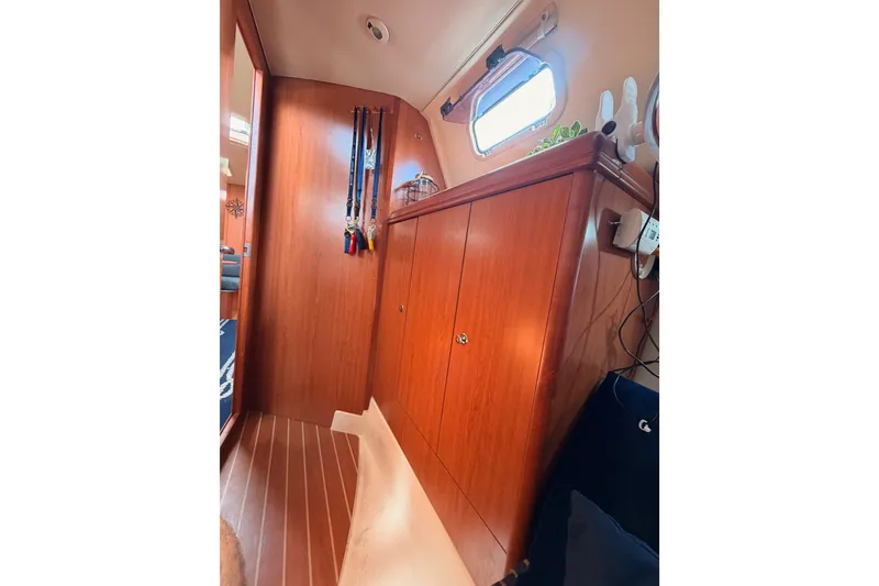 Slide: The Image of Interior of 2009 Hunter 33 sailboat with wooden cabinetry and nautical decor. - 45