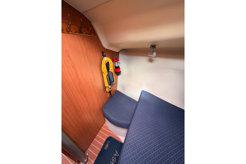 Slide: The Image of Interior cabin of 2009 Hunter 33 sailboat with seating and safety equipment. - 56