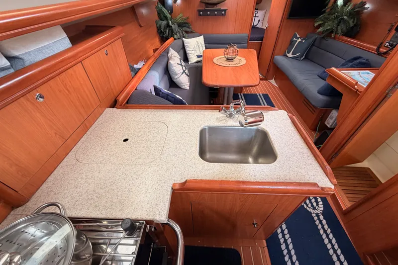 Slide: The Image of Interior of 2009 Hunter 33 sailboat with wooden cabinetry and cozy seating area. - 40