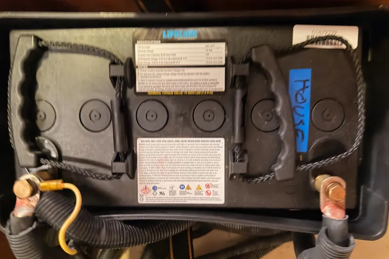 Slide: The Image of Battery compartment of a 2009 Hunter 33 boat with labeled connections. - 68