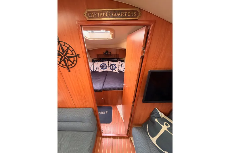 Slide: The Image of Cozy 2009 Hunter 33 sailboat interior with nautical-themed captain's quarters. - 54