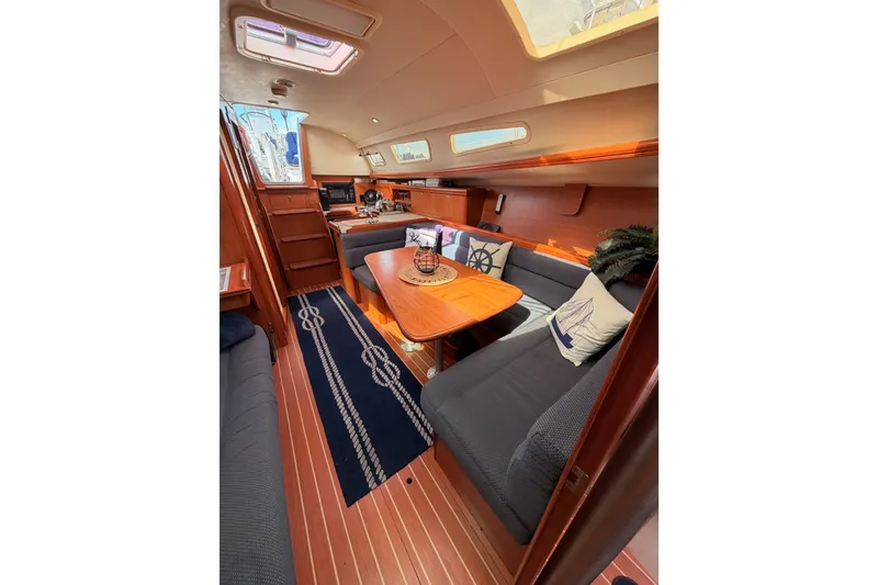 Slide: The Image of Interior of 2009 Hunter 33 sailboat with cozy seating and nautical decor. - 59