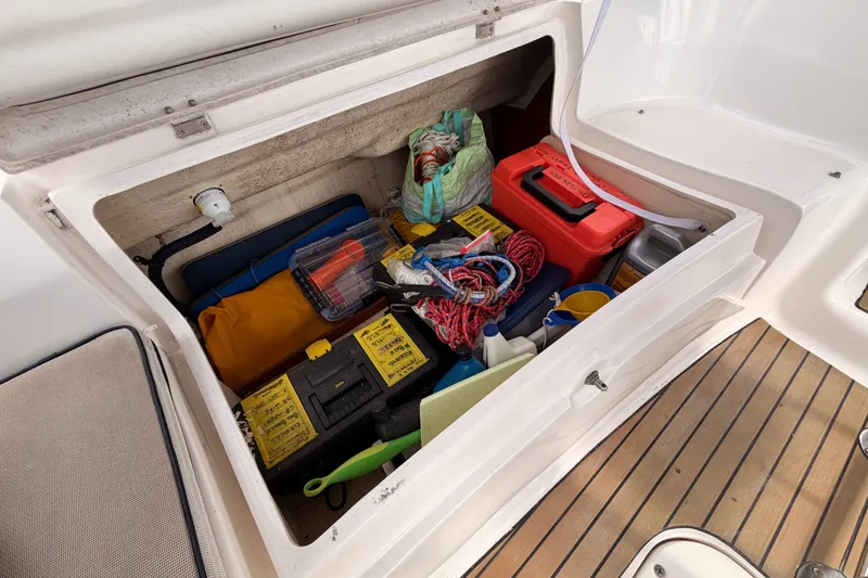 Slide: The Image of Storage compartment on a 2009 Hunter 33 sailboat filled with tools and supplies. - 33